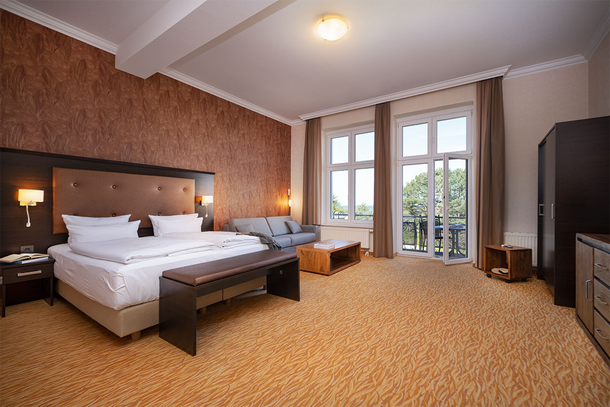 Doppelzimmer im Strandhotel Preußenhof mit Sofa, Balkon und Meerblick auf der Insel Usedom.