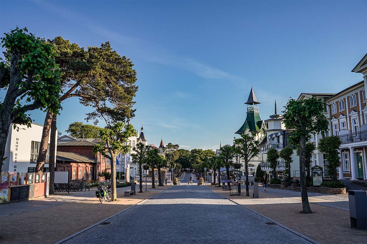 Baumgesäumte Promenade im Ortskern von Zinnowitz auf Usedom, Ziel für den Herbsturlaub mit historischer Bäderarchitektur
